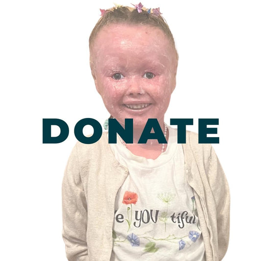 A picture of a little girl from the waist up wearing a cardigan, pearl necklace and a shirt that says BeYOUtiful on it which was inspired by her! 70% of profits support Harlequin Diva Foundation!