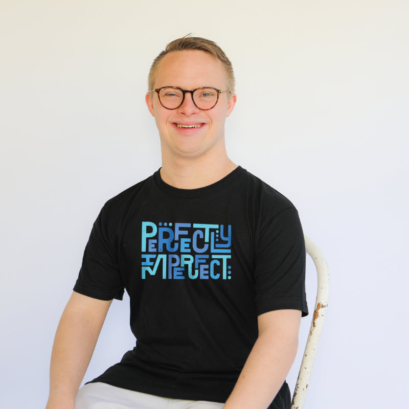 Man with down syndrome wears black perfectly imperfect tee