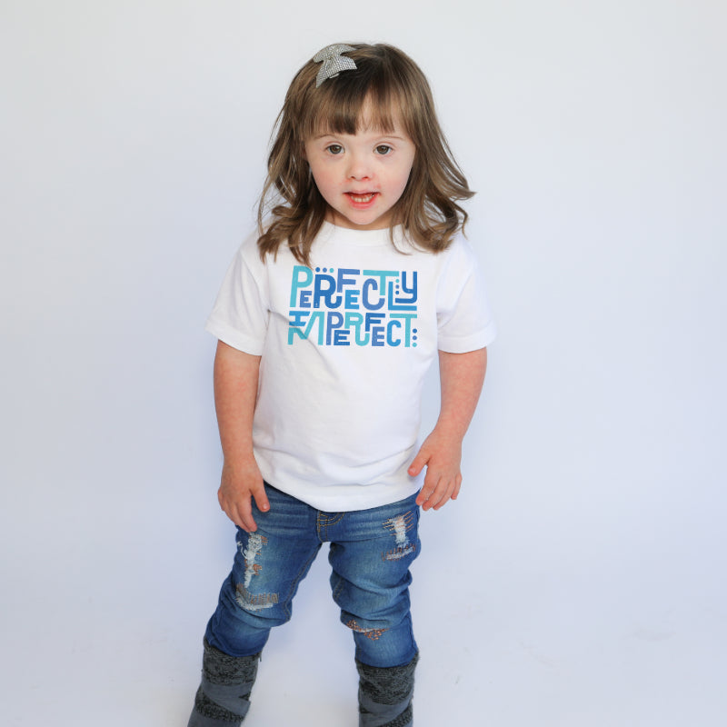 Girl with Down syndrome wearing Outshine Labels perfectly imperfect tee in white