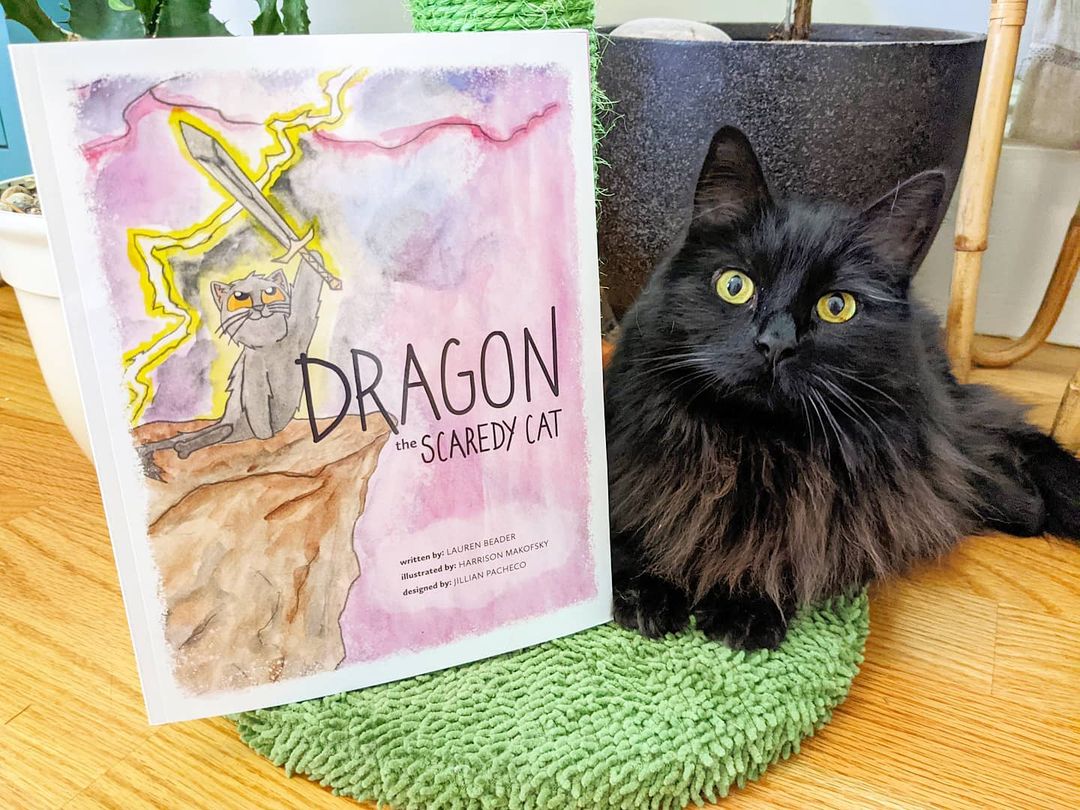 Dragon posing with Dragon the Scaredy Cat book 