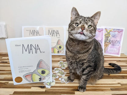 Maya poses with Meet Maya Cat books